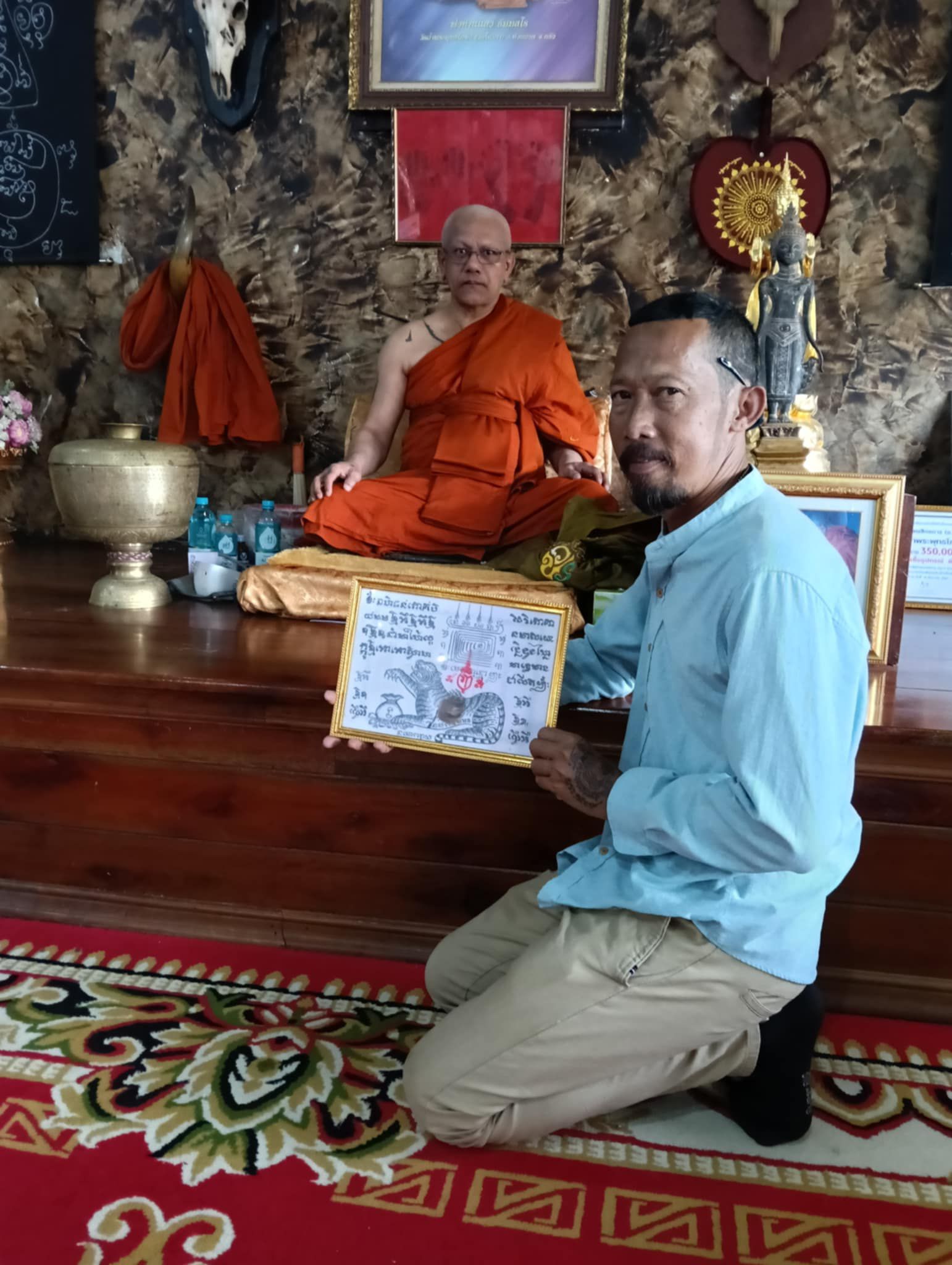 Ajarn Pol applying a Sak Yant in a sacred ceremony space