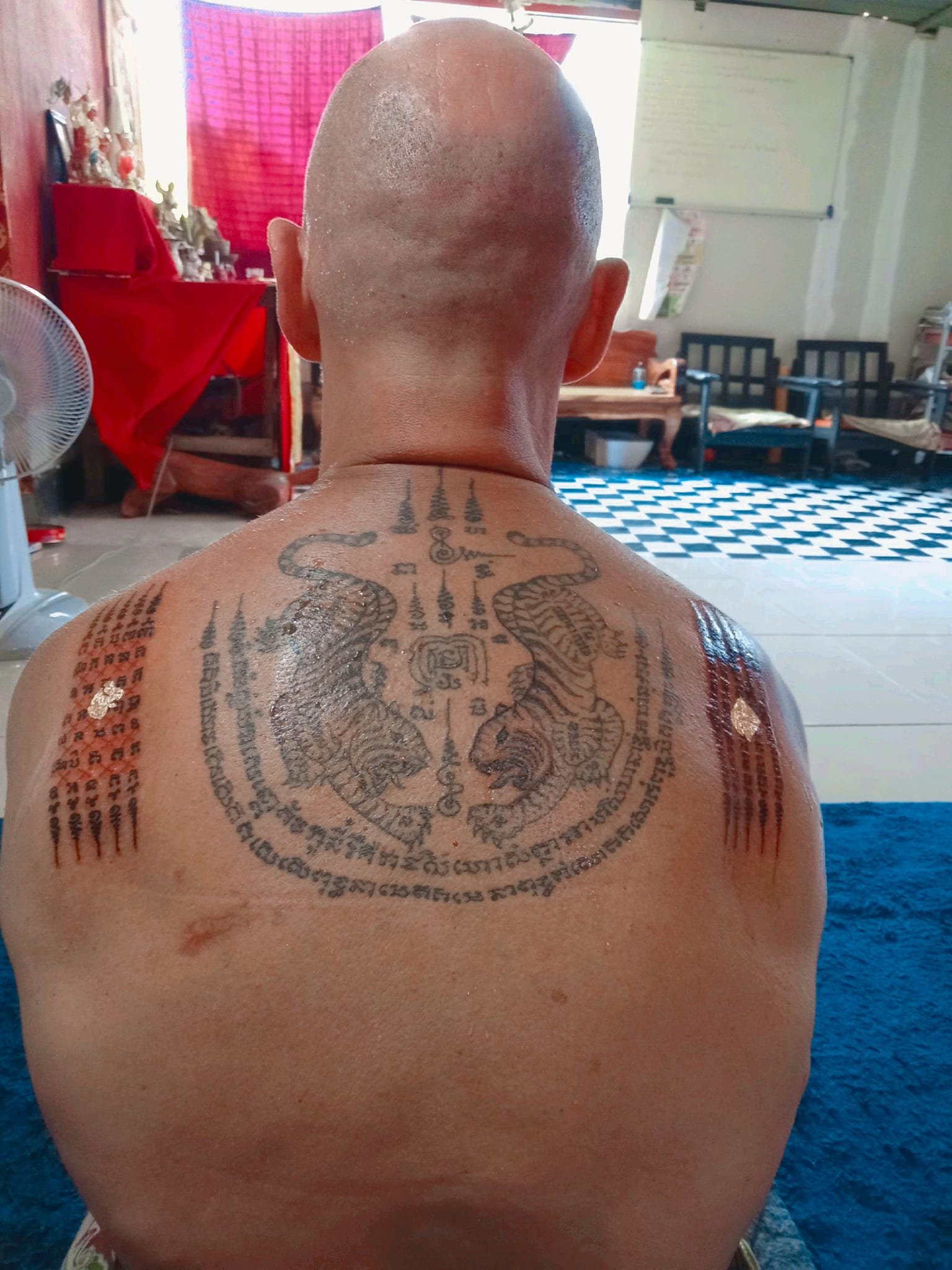Sak Yant blessing tattoo with sacred script