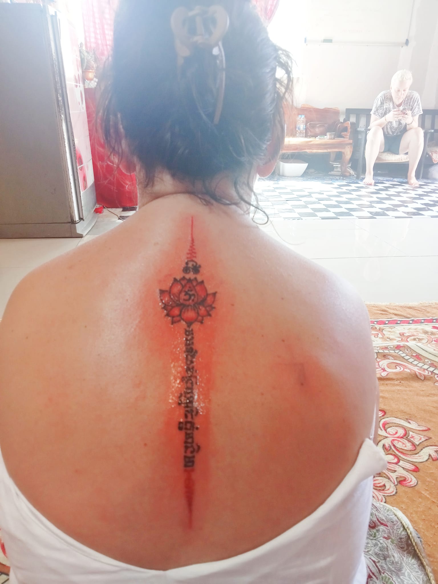 Fresh Sak Yant lotus tattoo on the upper back